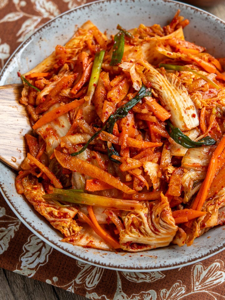 quick fresh kimchi freshly prepared in a large bowl with wooden spoon place in kimchi