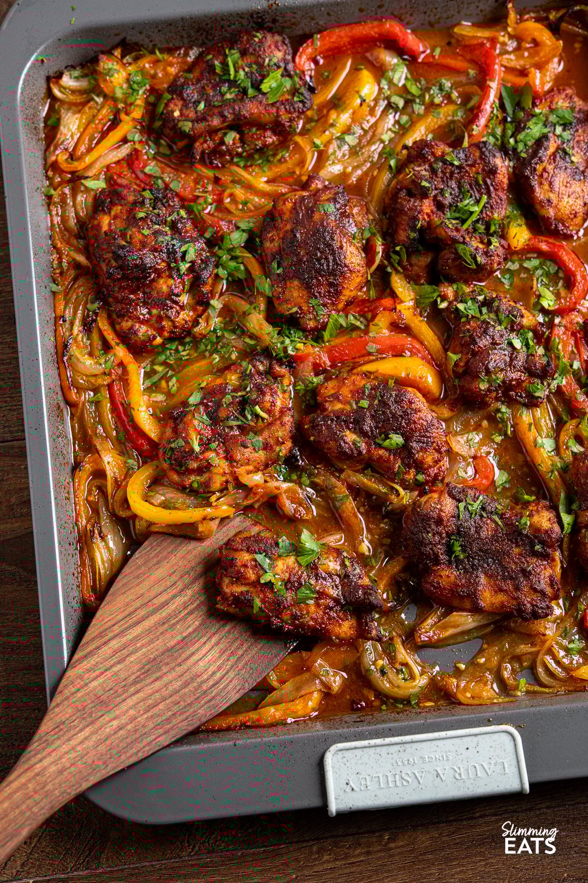 seasoned baked chicken thighs on a sheet pan with roasted juicy peppers with flavoursome broth. 