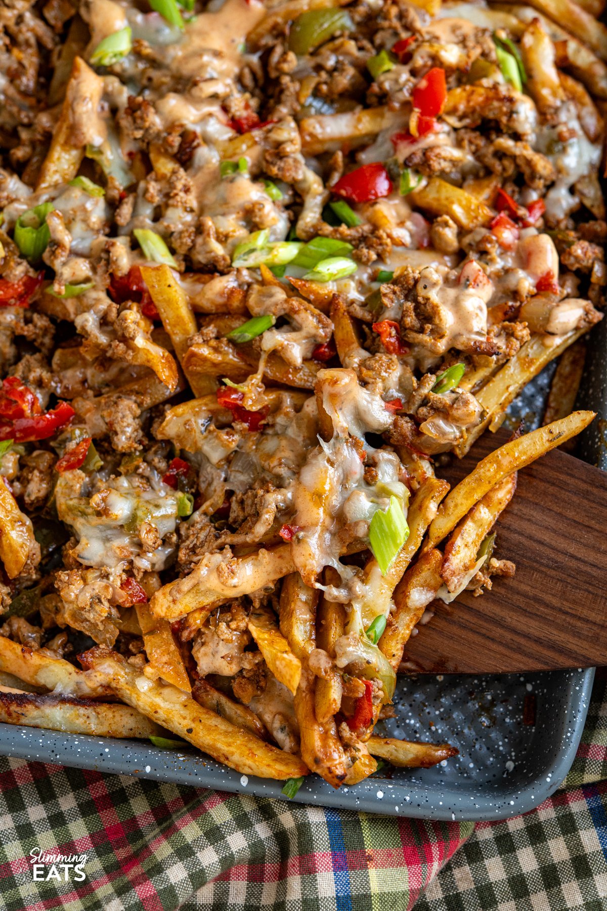 Say hello to the filthiest fries you’ll ever fall in love with. These Cajun Dirty Loaded Fries take all the bold, savoury flavour of dirty rice and throw it over a bed of golden homemade fries. A sizzling mix of ground beef and pork is cooked down with peppers and Cajun spices until rich and irresistible, then spooned generously over your chips like it owns the place. close up of cheesy cajun dirty loaded fries on baking sheet
