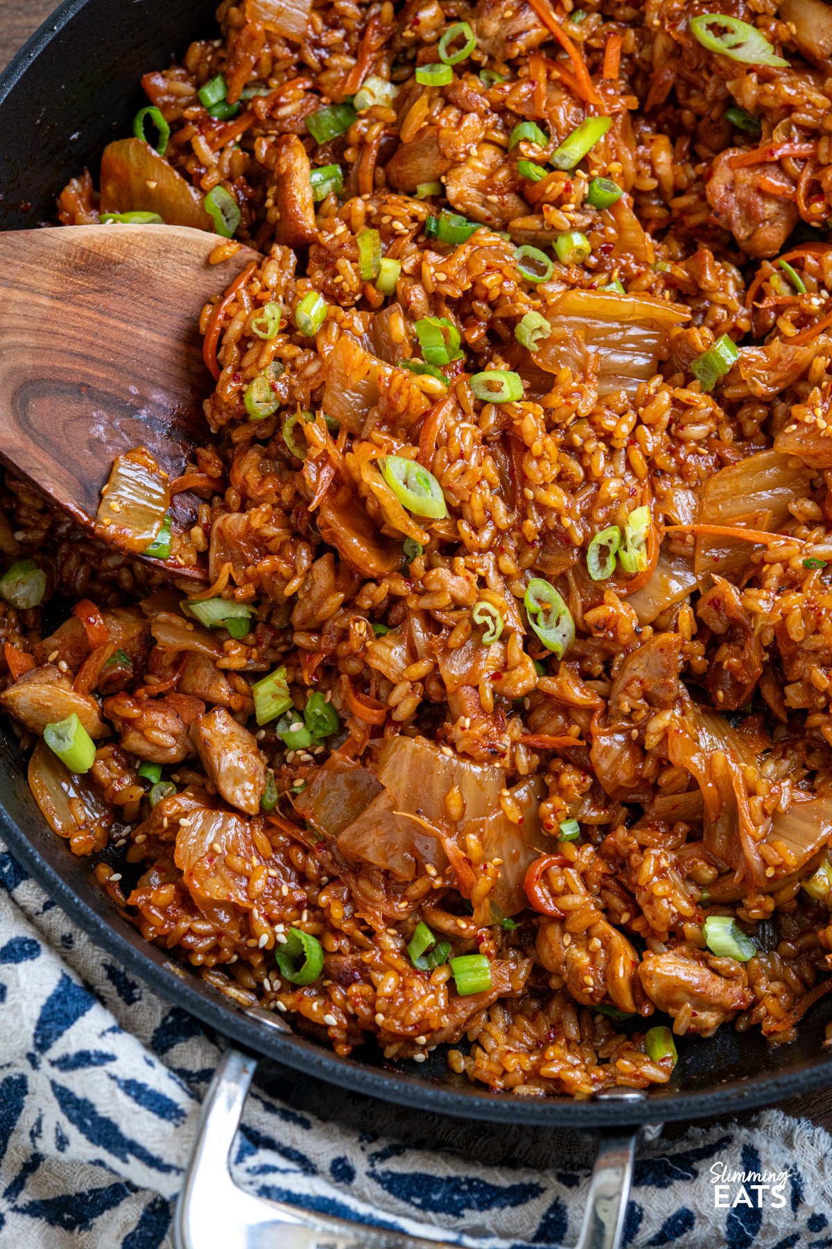 Spicy, savoury, and utterly moreish—this One Pot Chicken Kimchi Rice is a weeknight winner with bold, punchy flavour and minimal fuss. Tender chicken thighs simmer gently with tangy kimchi and a touch of sweetness, creating a rich, satisfying dish that brings comforting Korean-inspired vibes to your dinner table. close up of One Pot Chicken Kimchi Rice in all clad frying pa