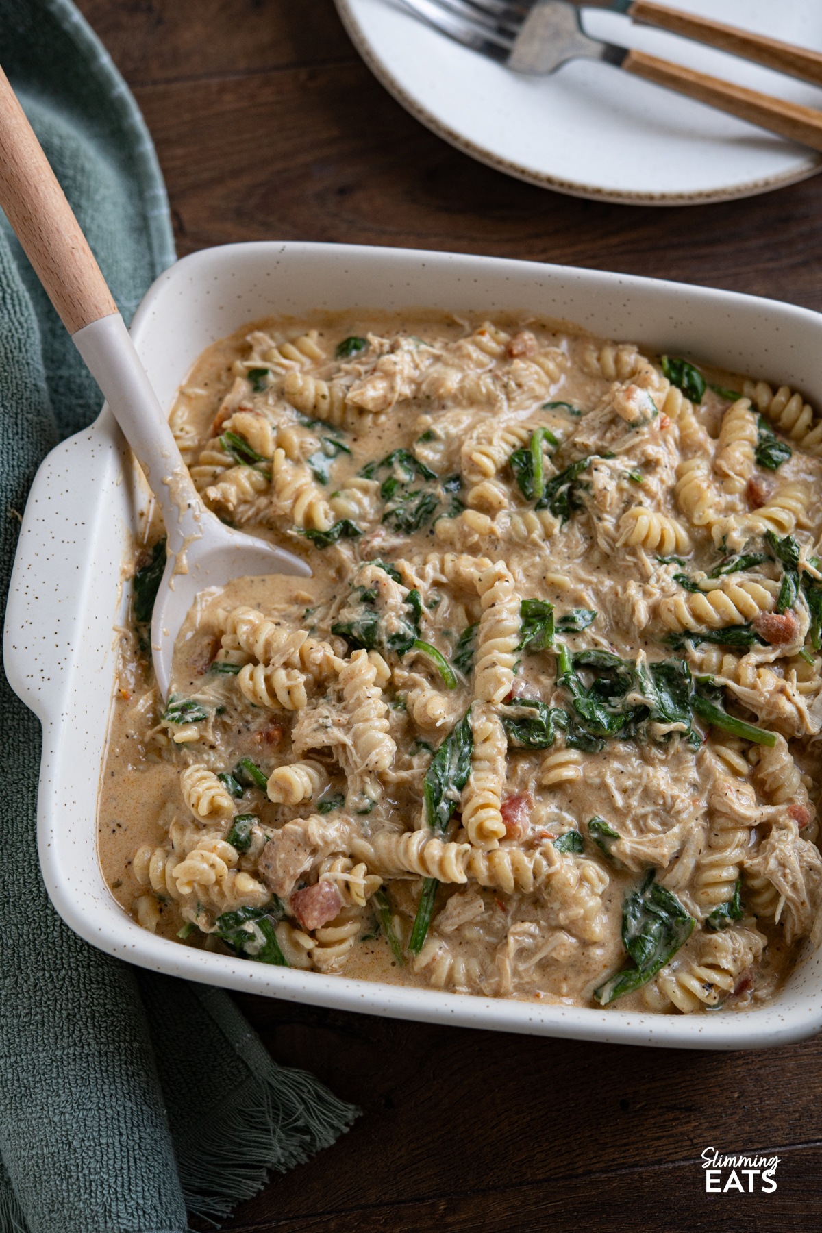 This Slow Cooker Creamy Garlic Chicken Spinach Pasta is an effortless, all-in-one slow cooker meal that’s rich, comforting, and perfect for busy weeknights. Slow Cooker Creamy Garlic Chicken Spinach Pasta in oven dish ready to be served