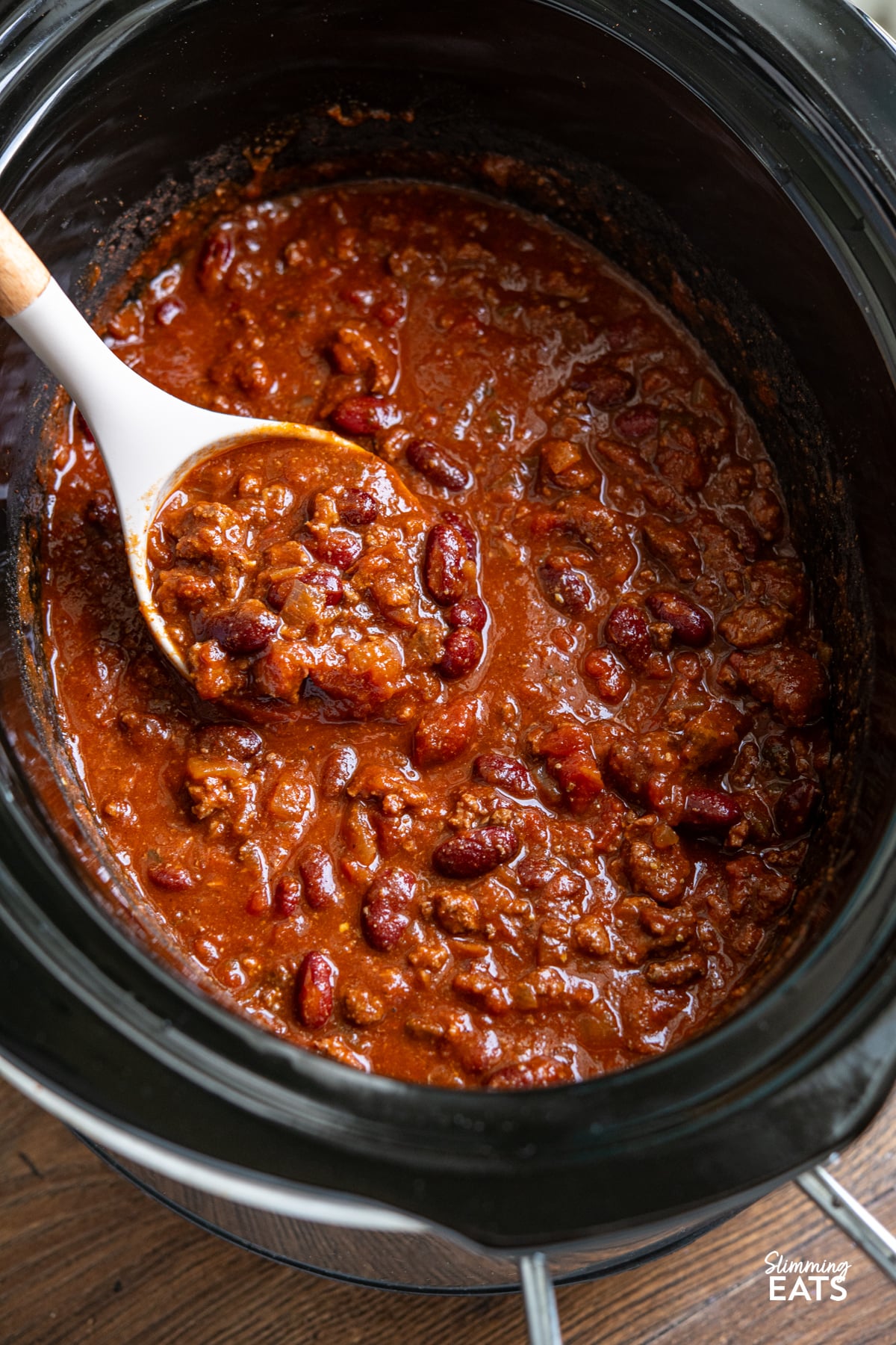 A hearty, flavour-packed slow cooker beef chilli with a rich salsa-infused sauce, tender beans and smoky spices for an easy meal the whole family will love. Slow Cooker Salsa Beef Chilli in a slow cooker with ladle
