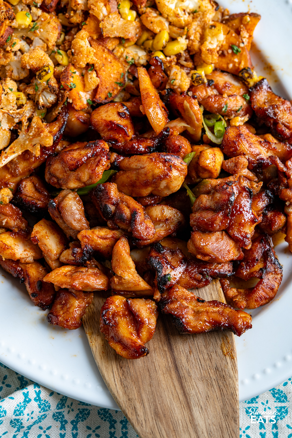 Air Fryer Hot Honey Chicken  on white oval plate with roasted butternut and cauliflower
