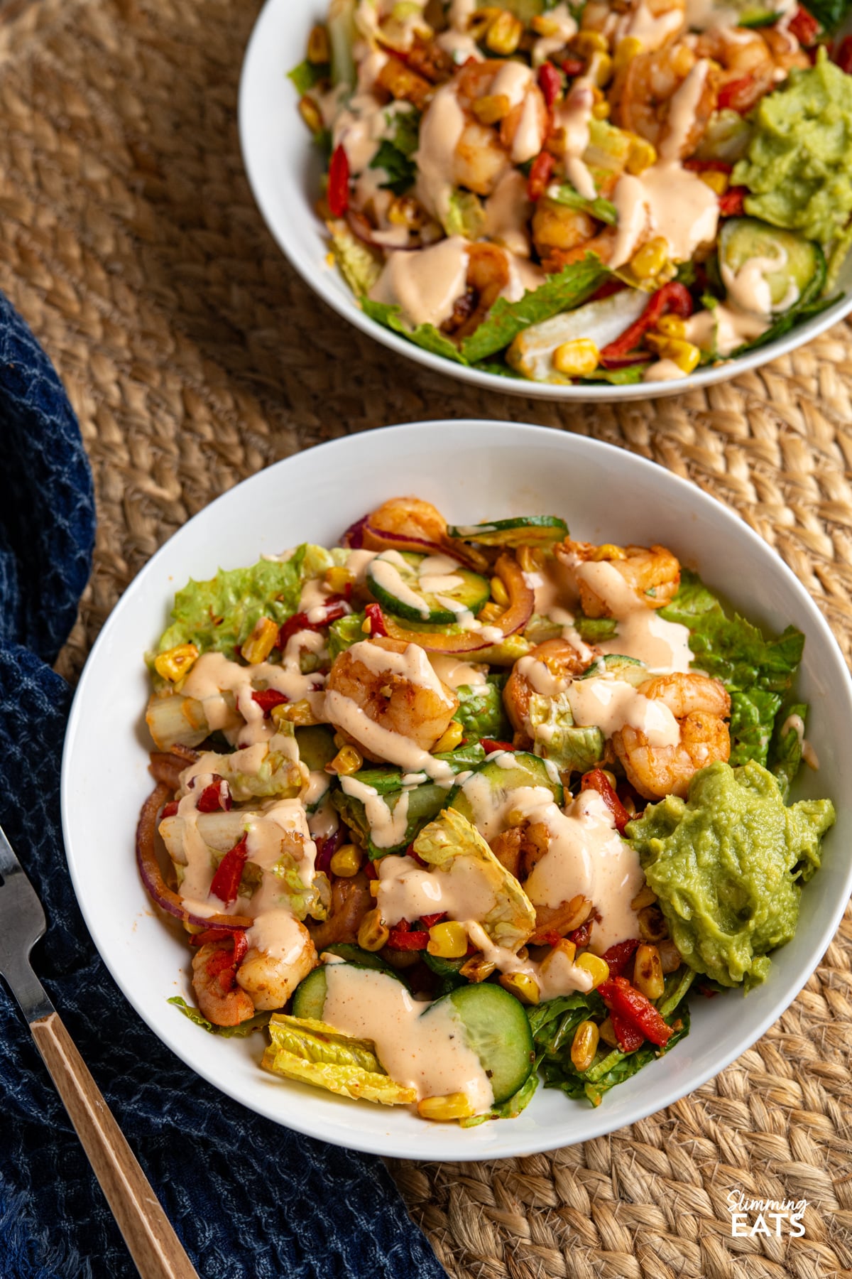 tossed Peri Peri King Prawn Salad  in white bowls drizzled with perinaise