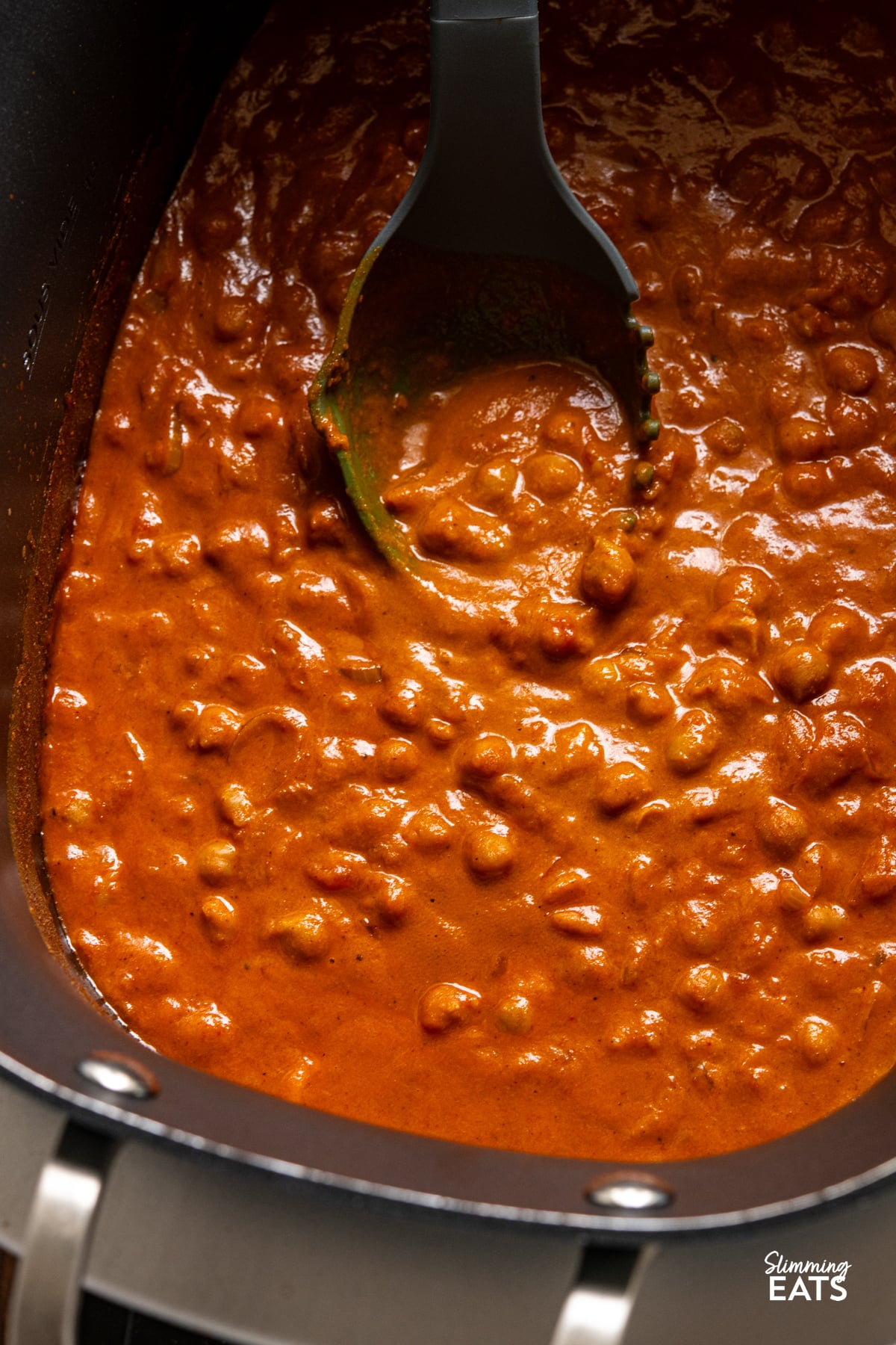 Tomato Chickpea Curry in the slow cooker with spoon