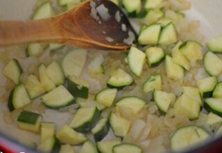 sauteed onion, garlic and zucchini in a pan